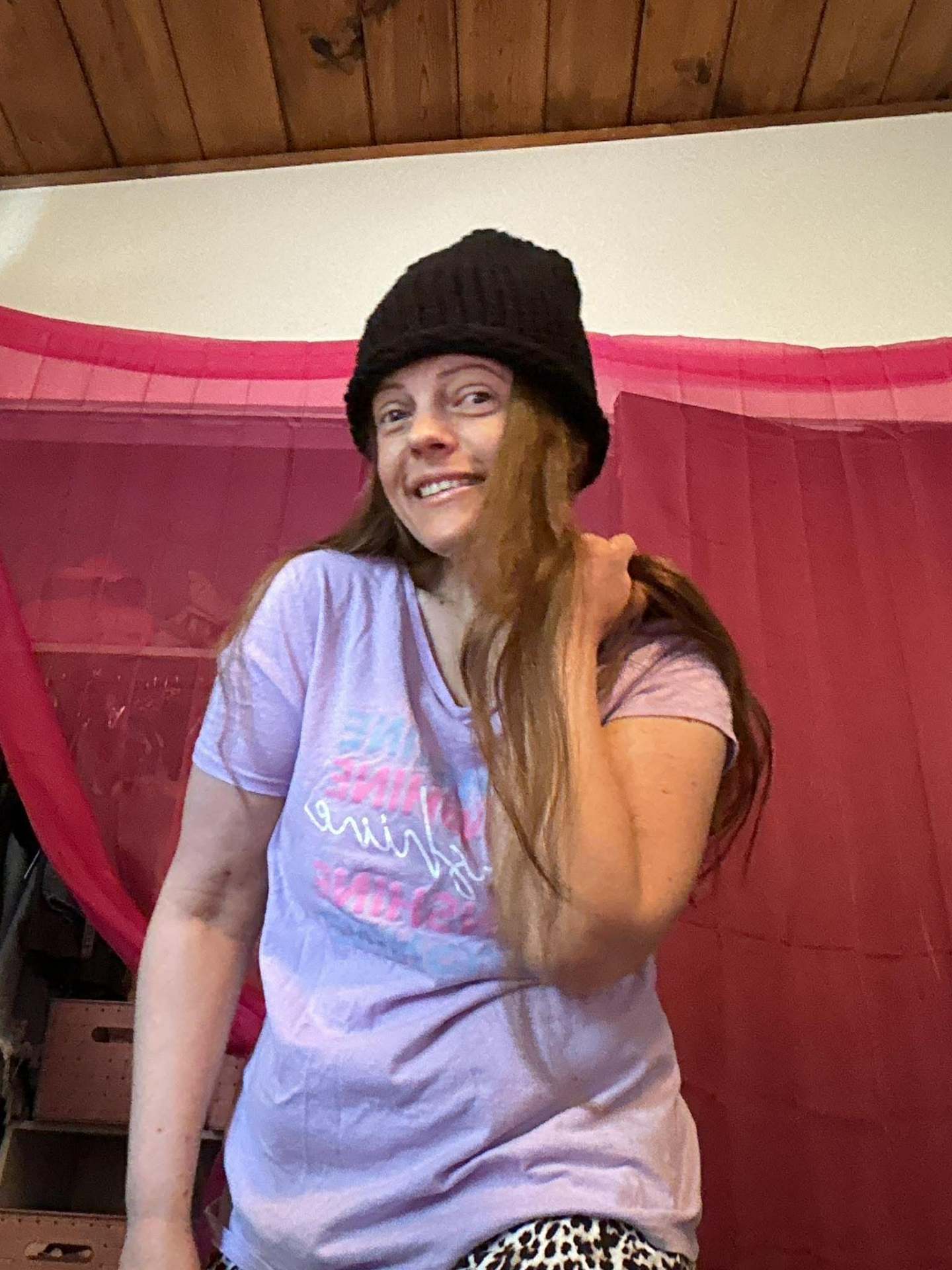 Kailye in a hand-knit black beanie, side view