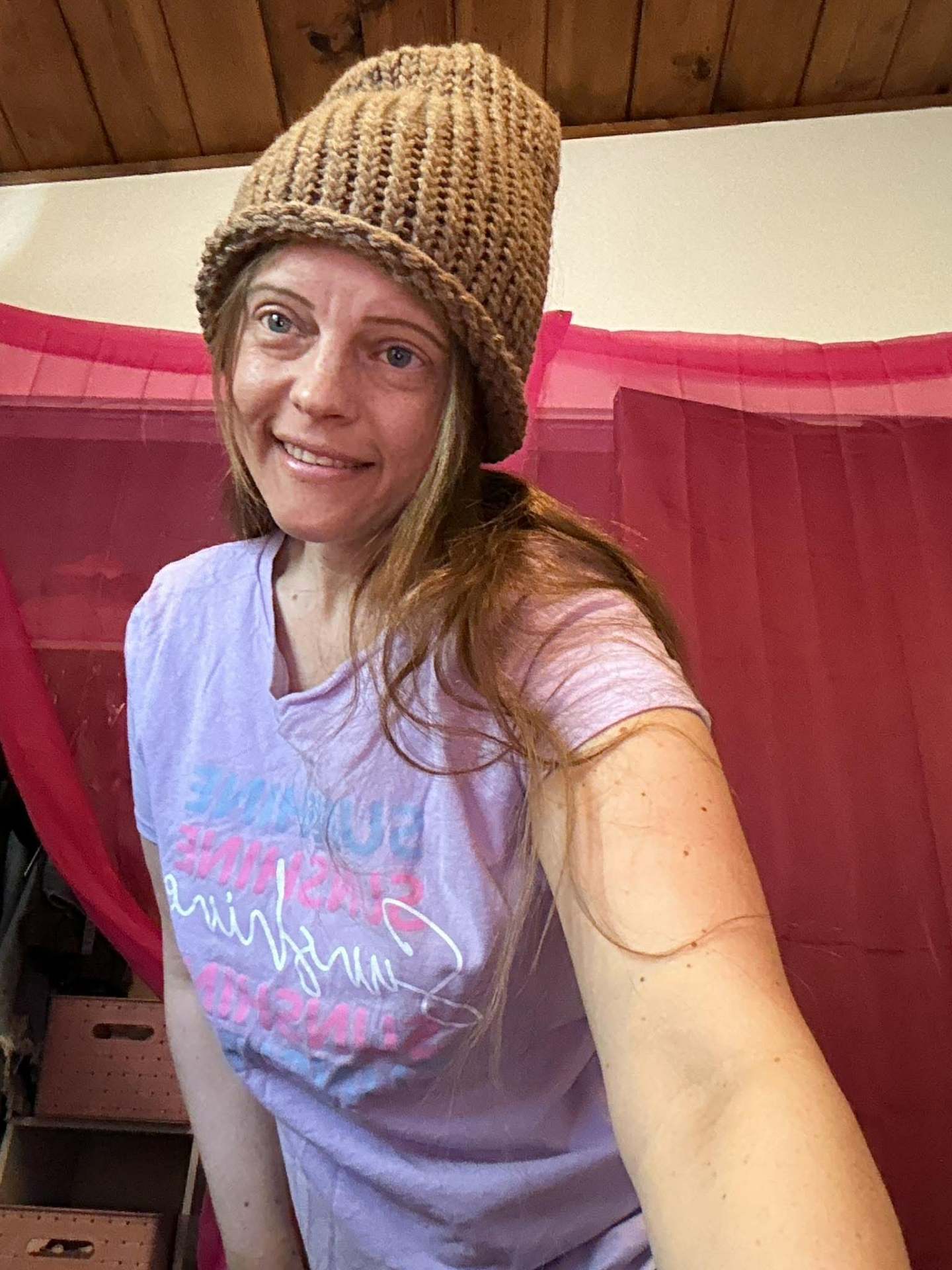 Kailye in a hand-knit caramel ribbed beanie