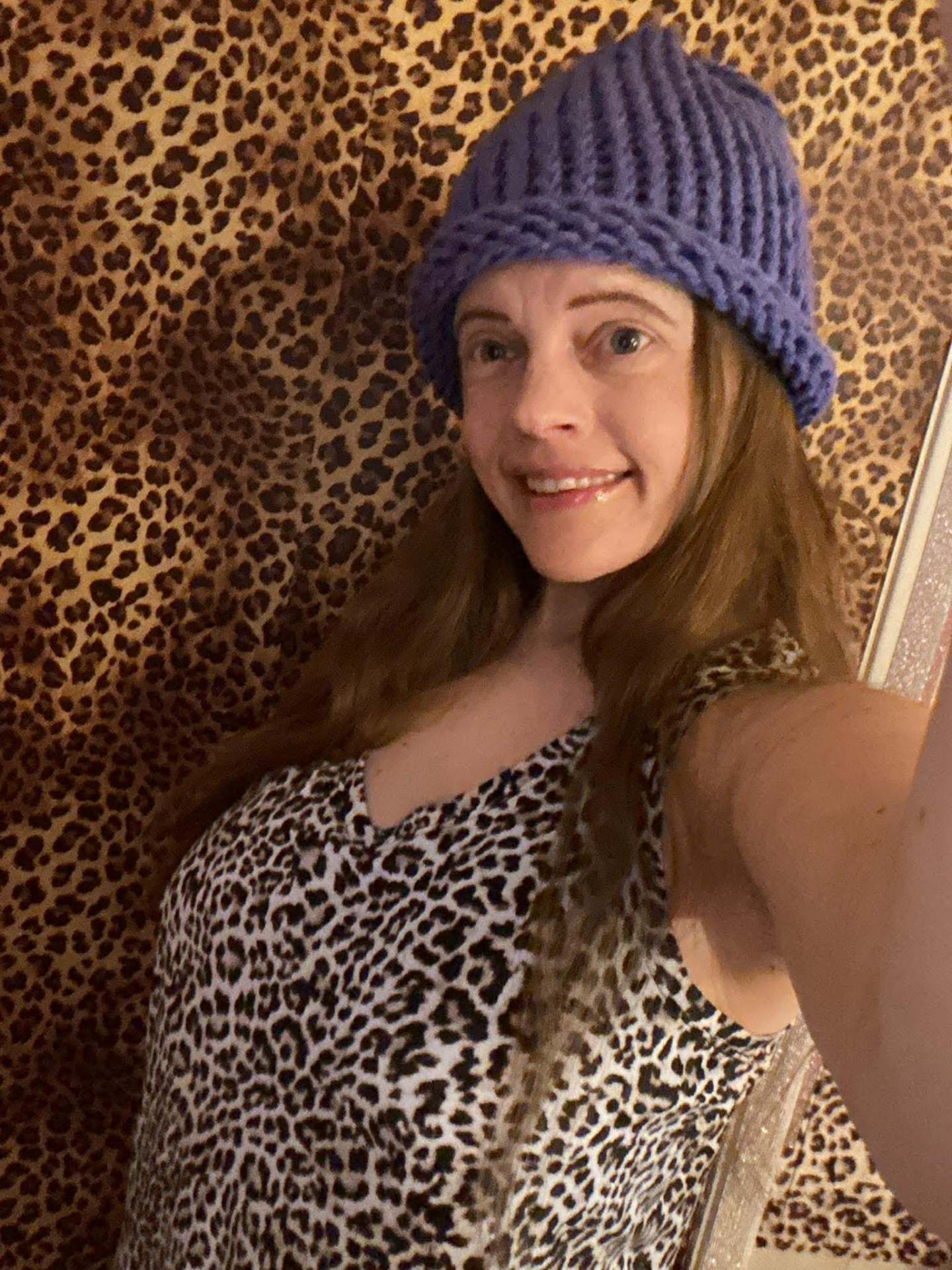 Kailye wearing a handmade purple knit beanie
